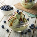 Blueberry Maple Matcha Creami in a bowl with fresh toppings