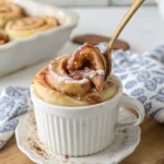 Microwave cinnamon roll in a white mug with glaze